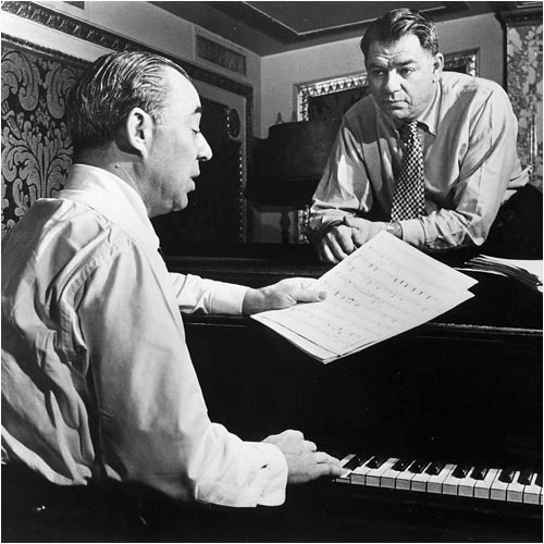 Richard Rodgers and Oscar Hammerstein playing songs from a musical at a piano